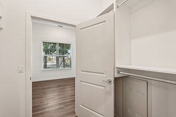 A white door is open to a room with a window